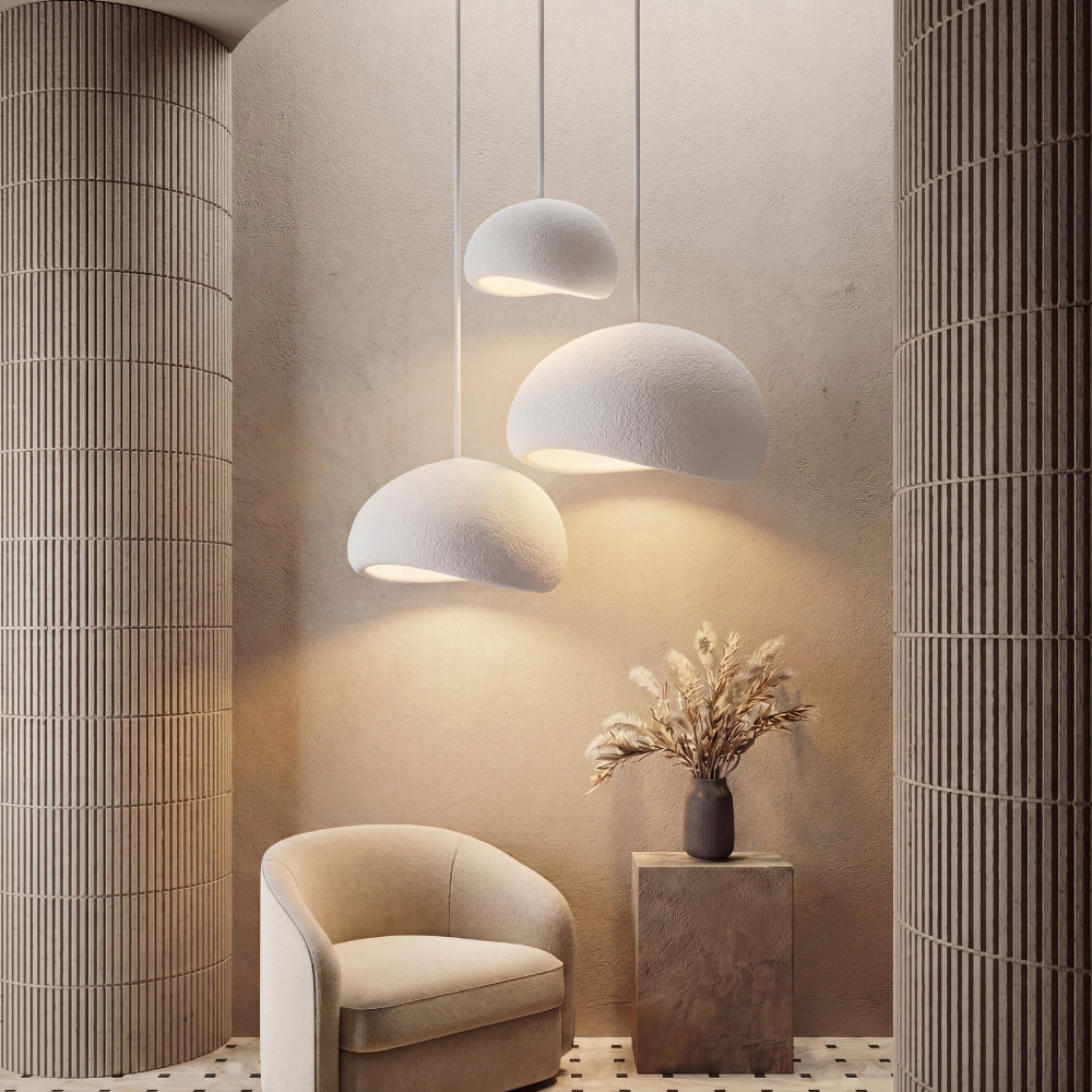 Textured Japandi pendant lights suspended above a lounge chair