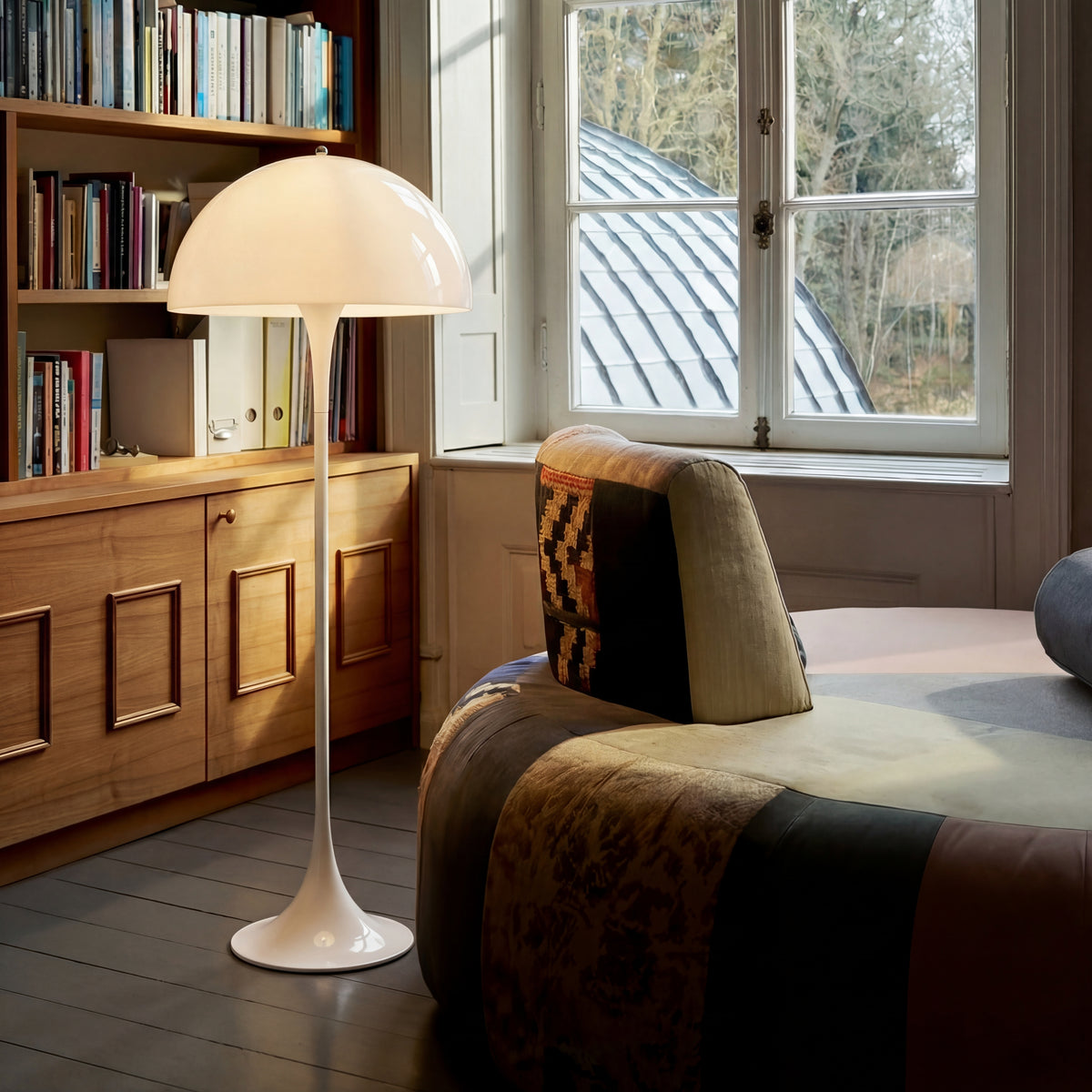 Modern floor lamp beside a lounge chair.